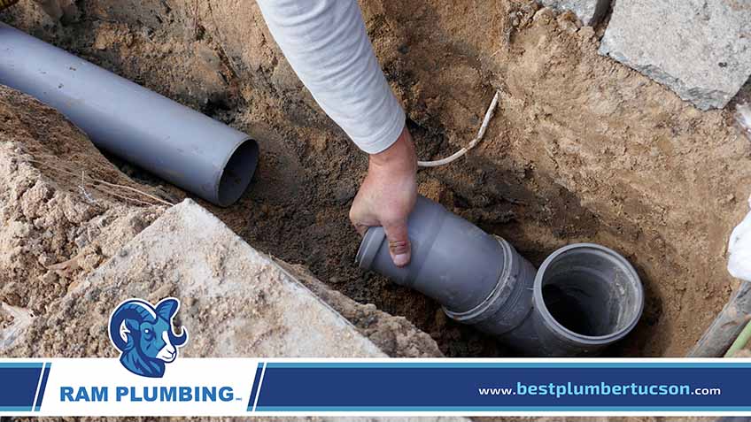 Plumber Installing a New Sewer Pipe