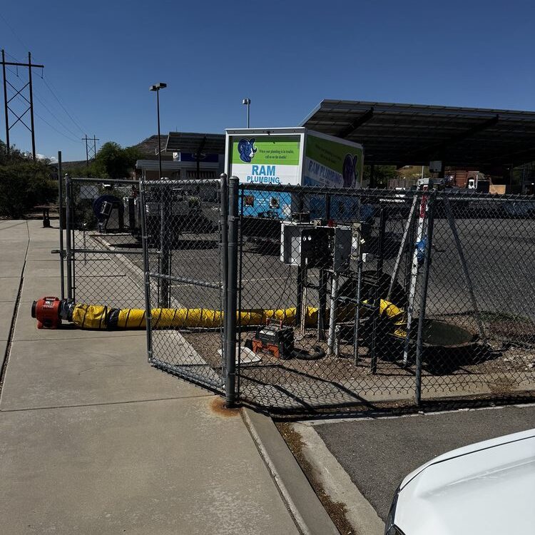 Plumber in Marana, AZ using professional sewer inspection and vacuum equipment at outdoor job site